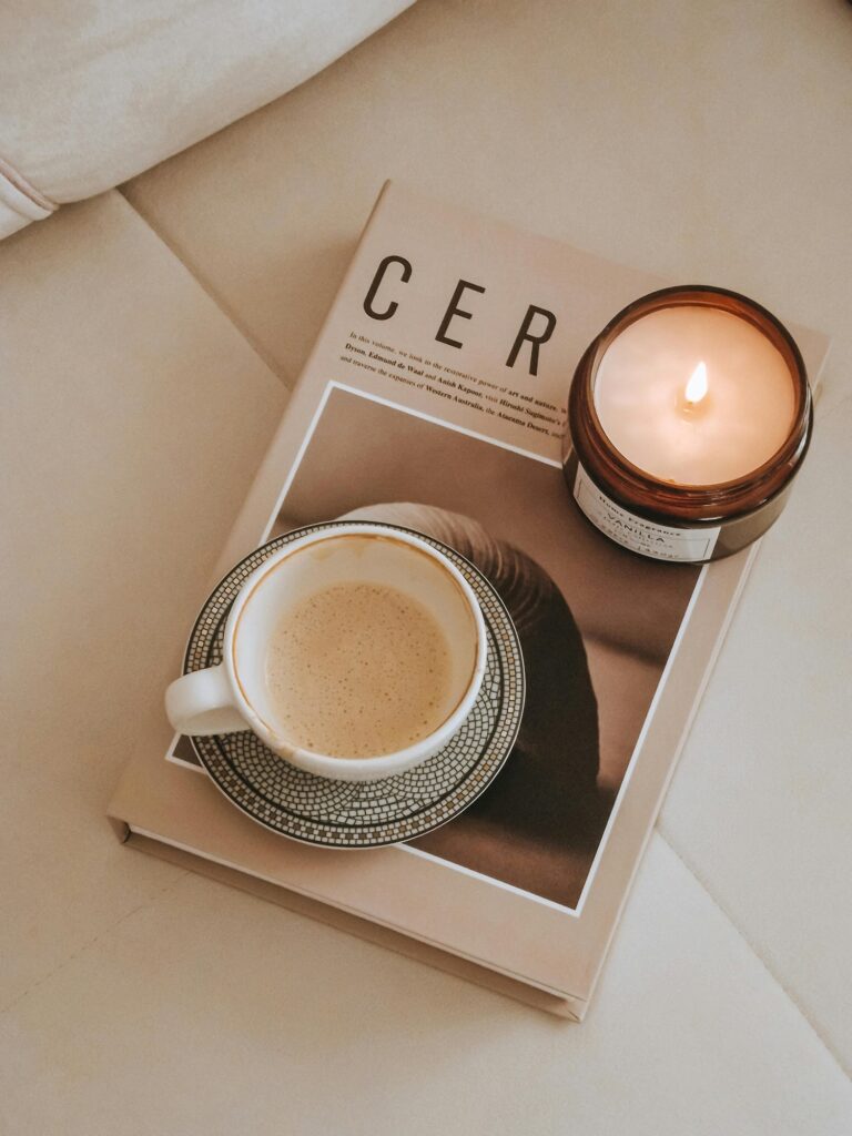 Coffee and candle arranged on a neutral coffee table